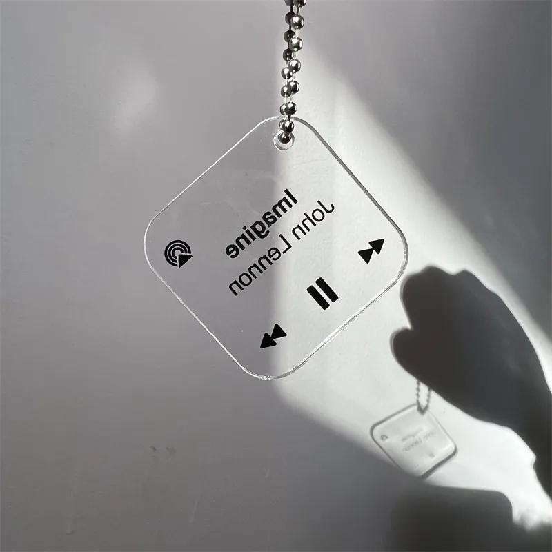 Transparent acrylic keychain with a printed music-player design on a ball chain