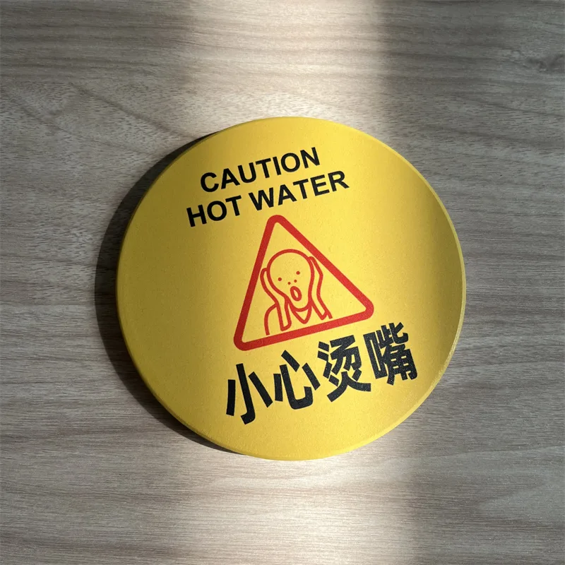 Round pin-back badge with a yellow caution hot-water design
