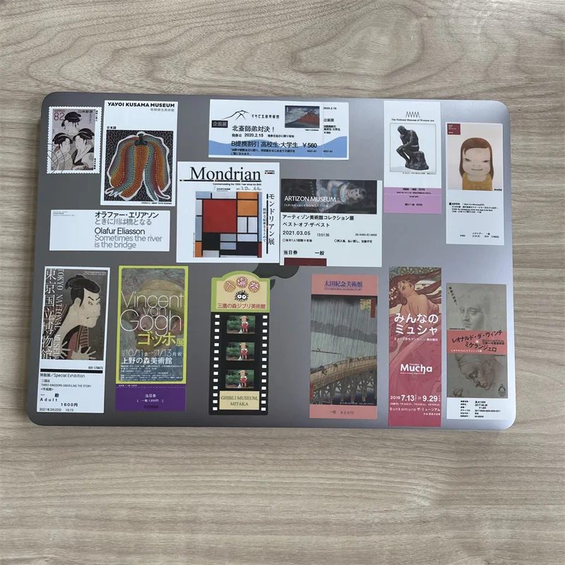 Board covered with printed museum-poster fridge magnets of many different designs and sizes
