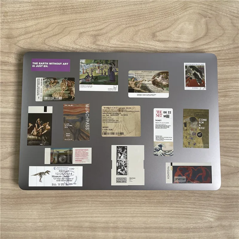 Collection of printed museum-ticket fridge magnets arranged on a metal board
