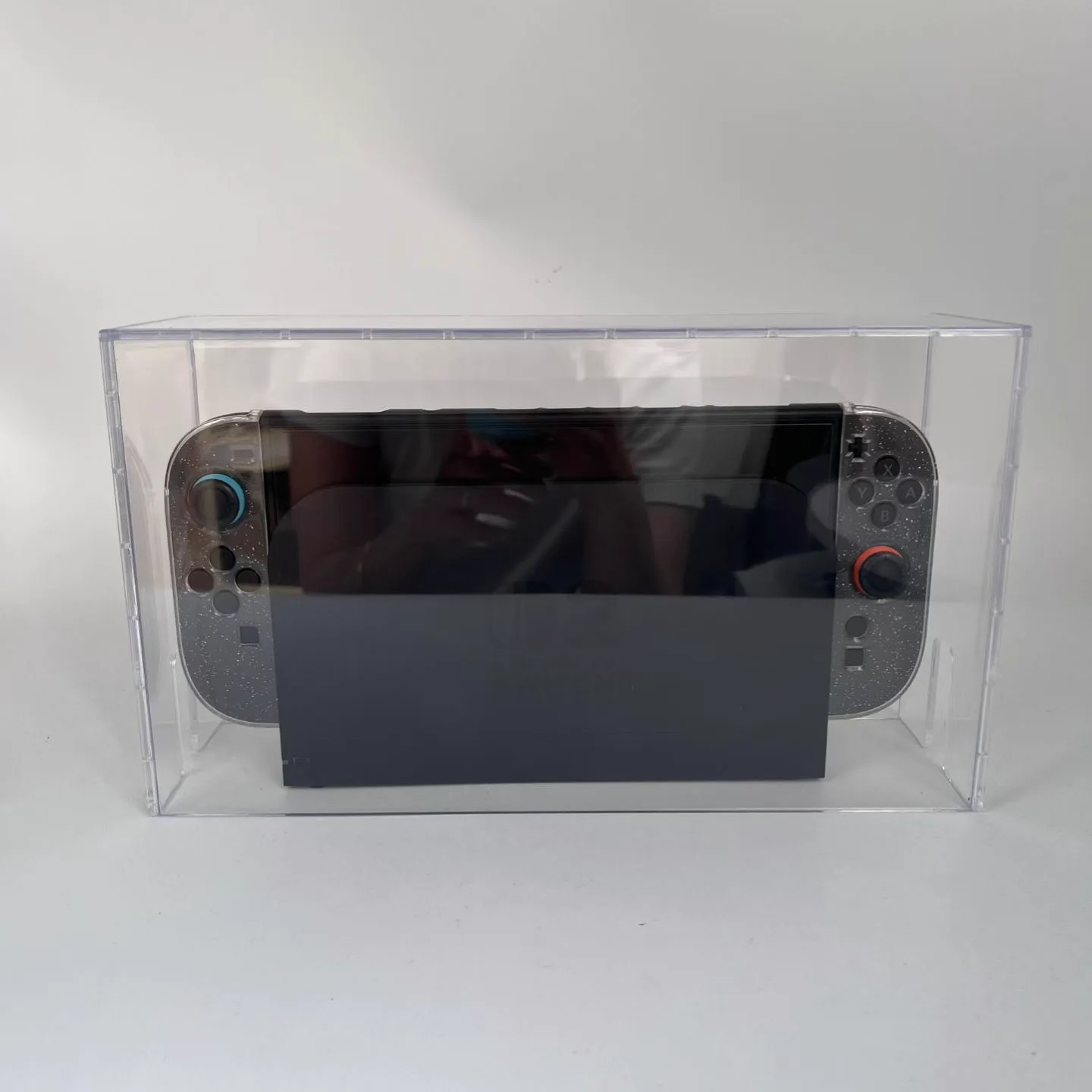 Clear rigid dust cover placed over a docked Nintendo Switch 2 console