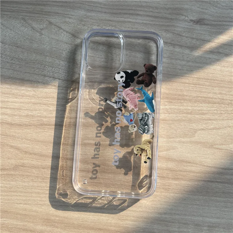 Almost fully clear phone case with one small printed element, photographed against sunlight on a wooden desk