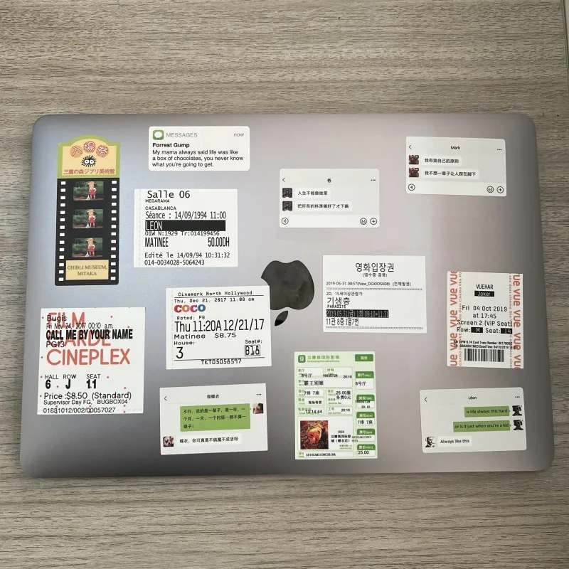 Cinema-ticket stickers covering the lid of a laptop
