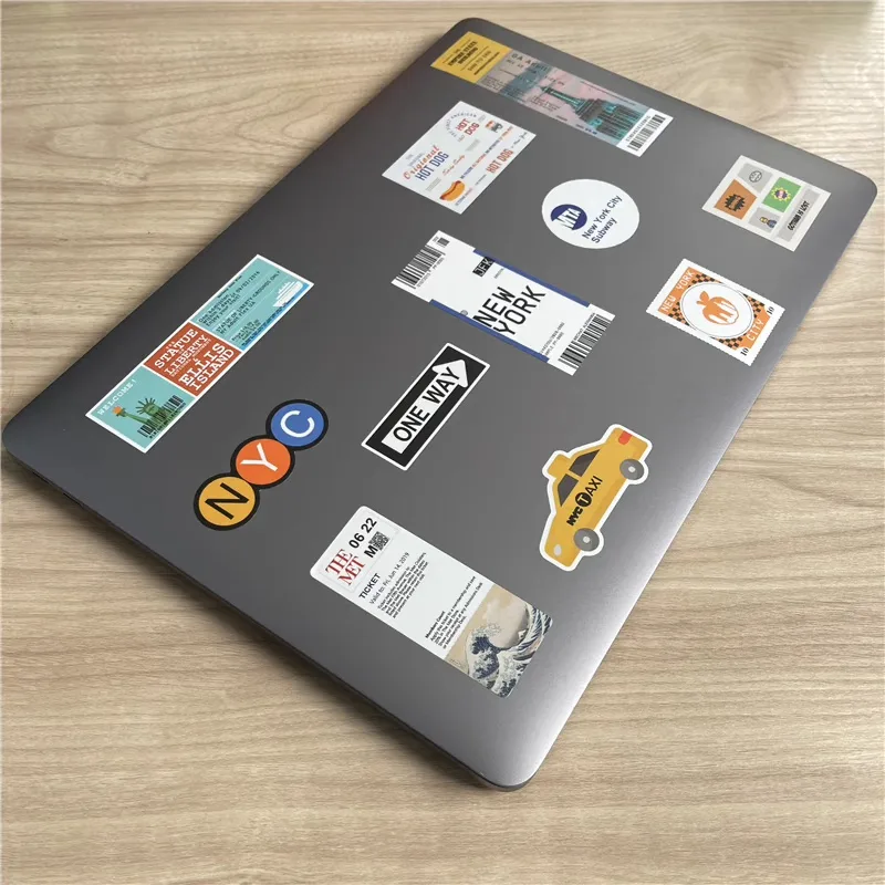 Laptop lid decorated with stamp-shaped art stickers